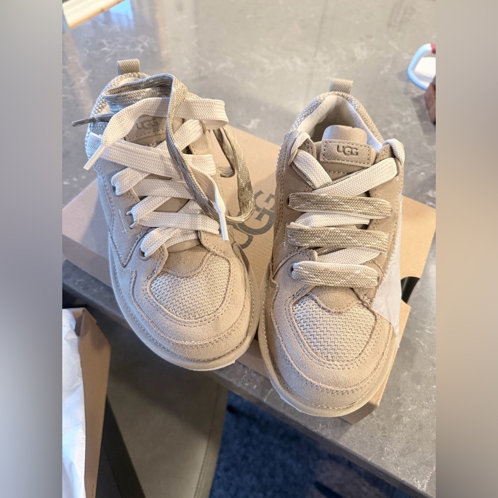 NWT UGG Tennis Shoes. Tan color Size 7 with suede and two different laces.